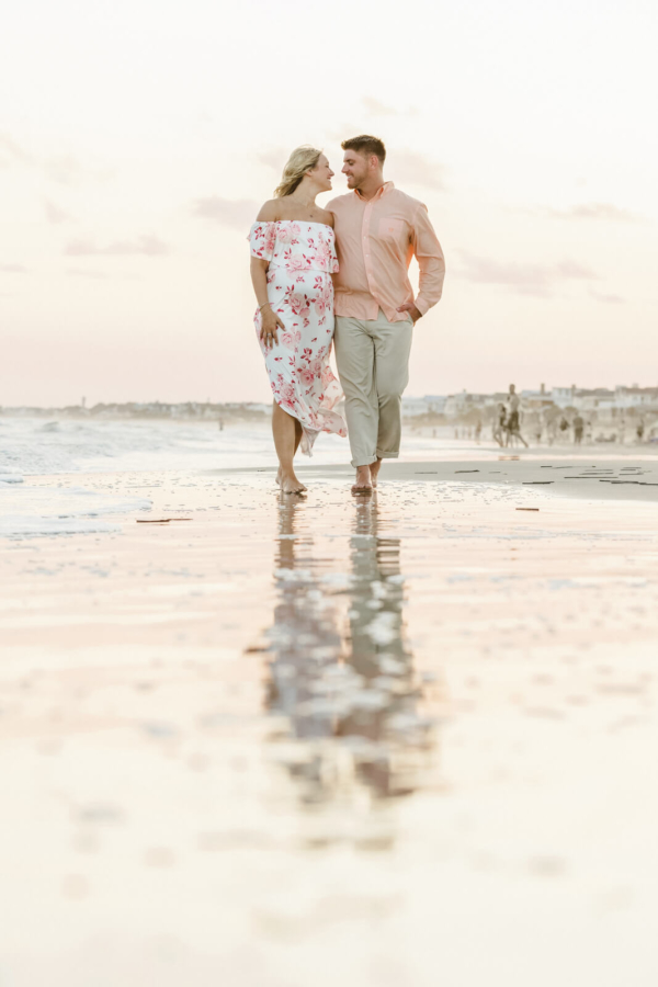 family photo charleston pregnant woman and her husband walking near sea