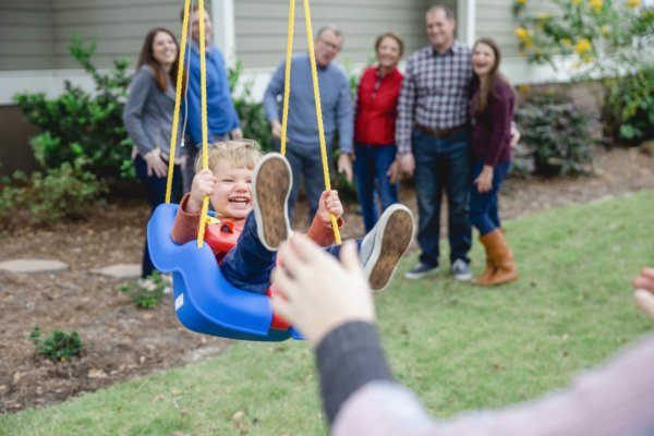 family photo charleston child is sitting in swing and laughing 