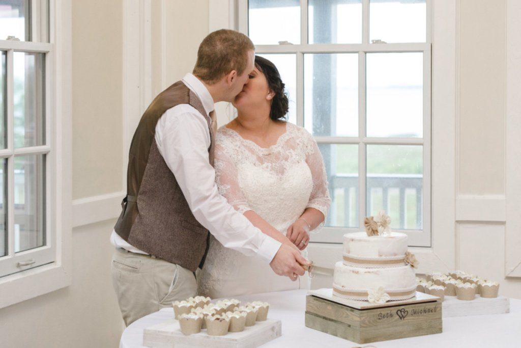 bride and groom cutting the wedding cake