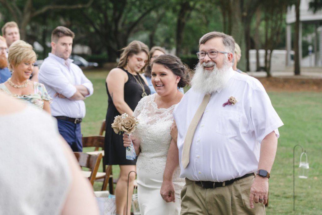 bride is walking with her dad