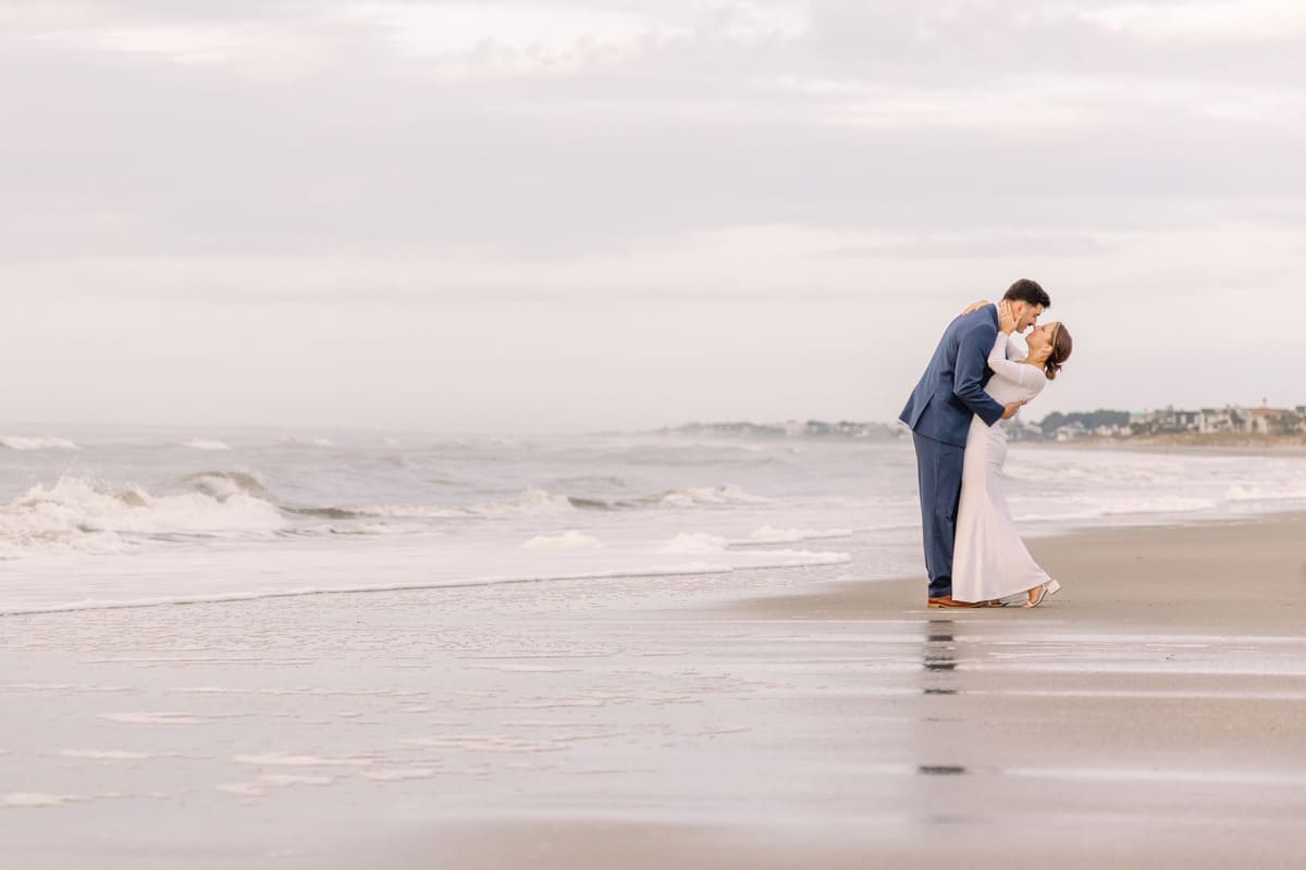 couple under pier sunrise isle of palms