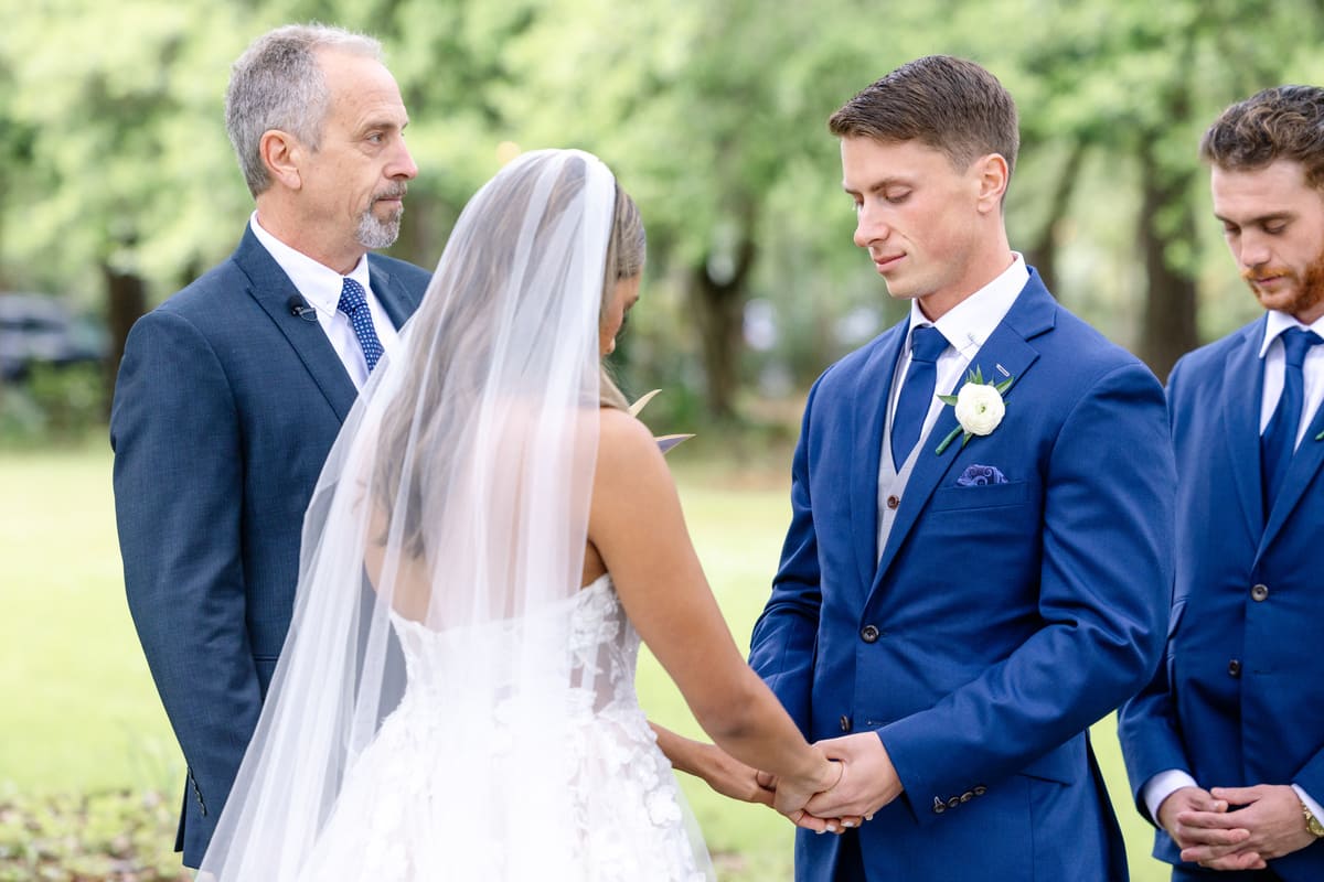 couple holding hands oak tree