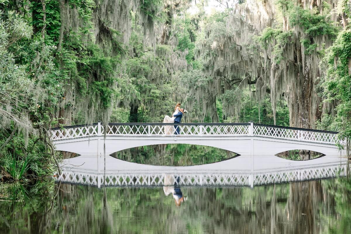 Happy Eloping Couple On a Bridge Over Water