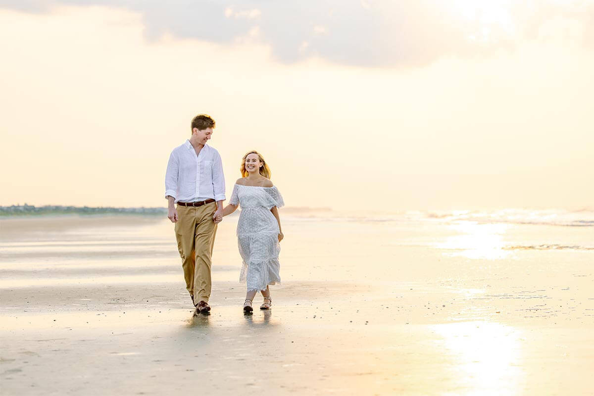 Newly married couple walking on Isle of Palms beach after their Charleston elopement