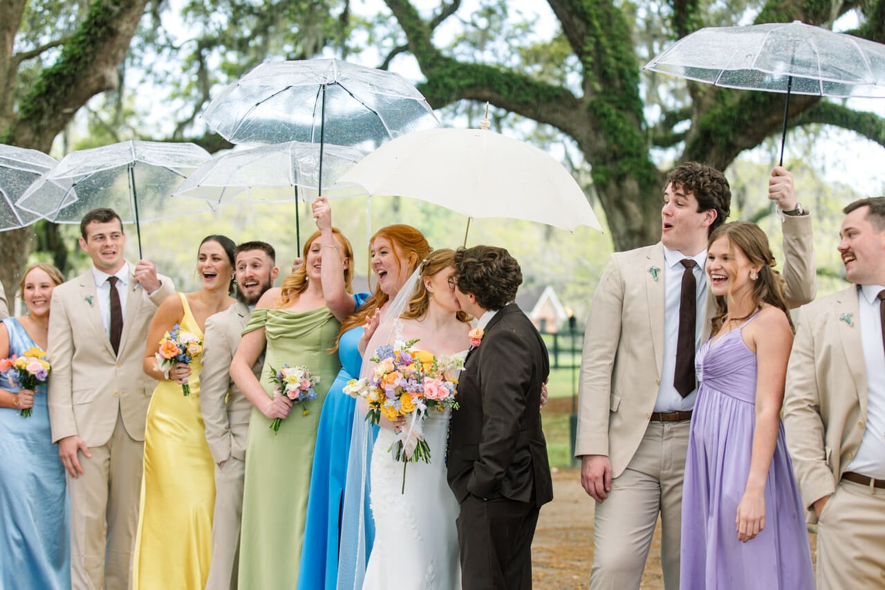 boone hall wedding couple kissing under umbrella