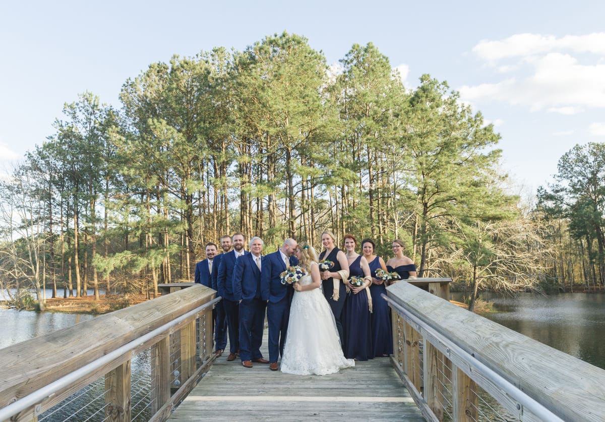 the Lake House at Bulow wedding venue bridal party on bridge