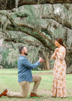 couple proposal under oaks magnolia