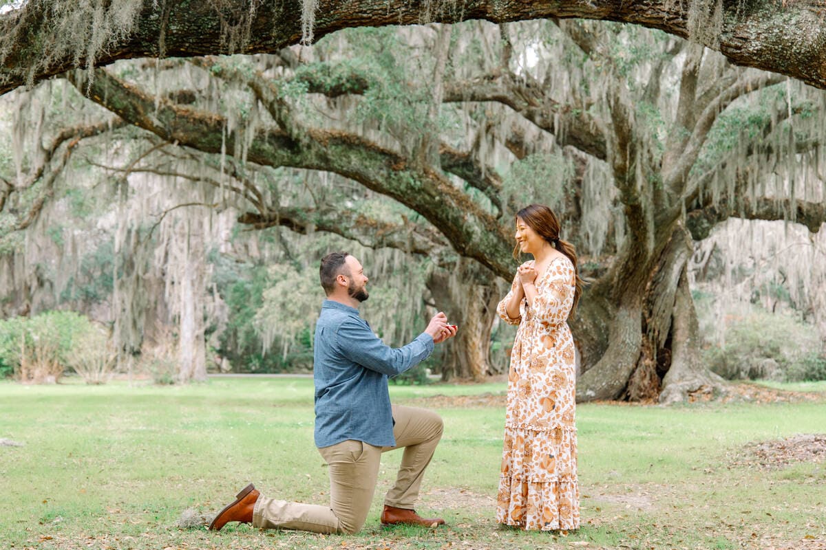 couple proposal under oaks magnolia