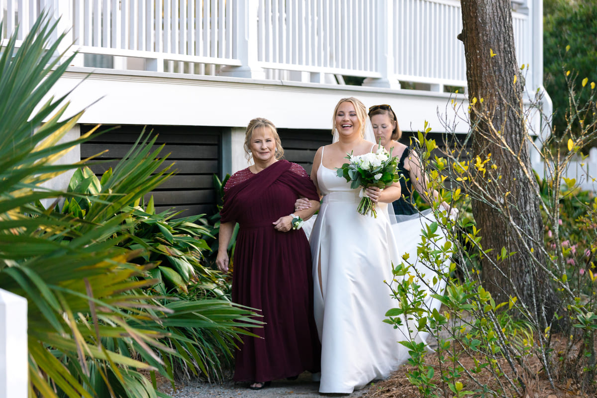 mom and bride walking down the aisle