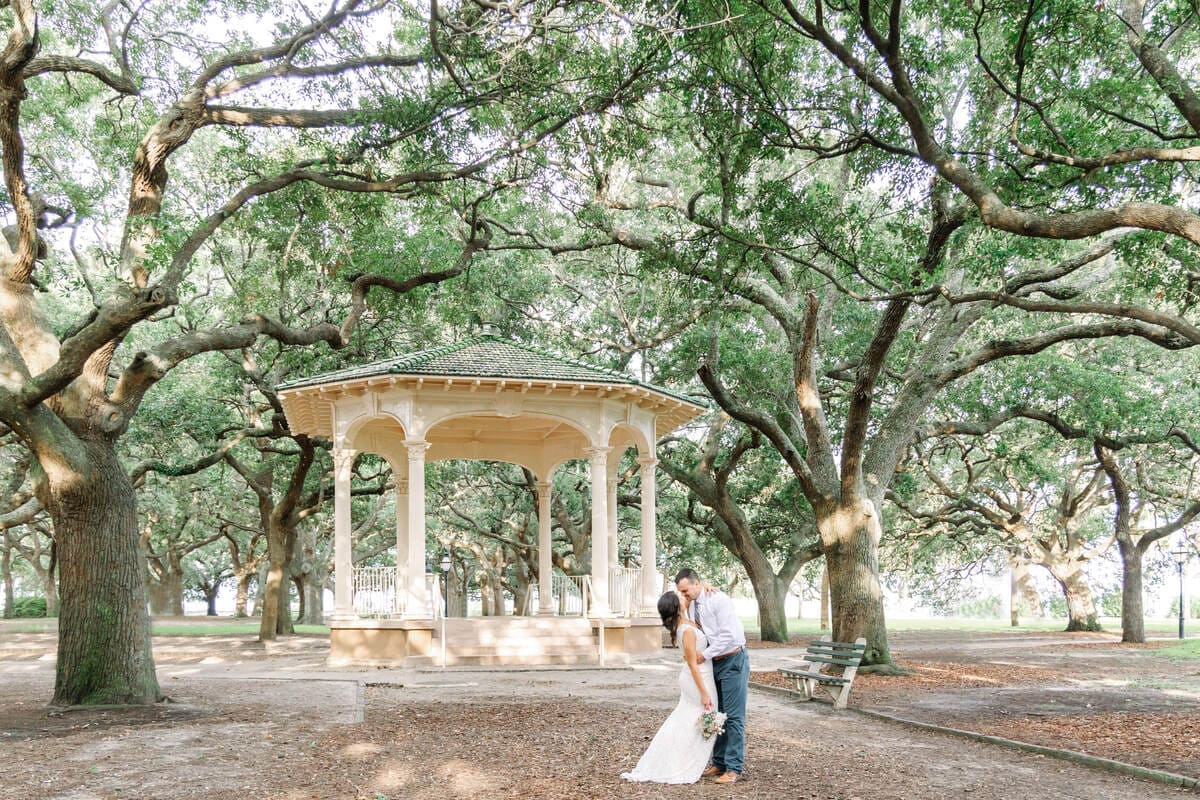 bride and groom under oak trees charleston