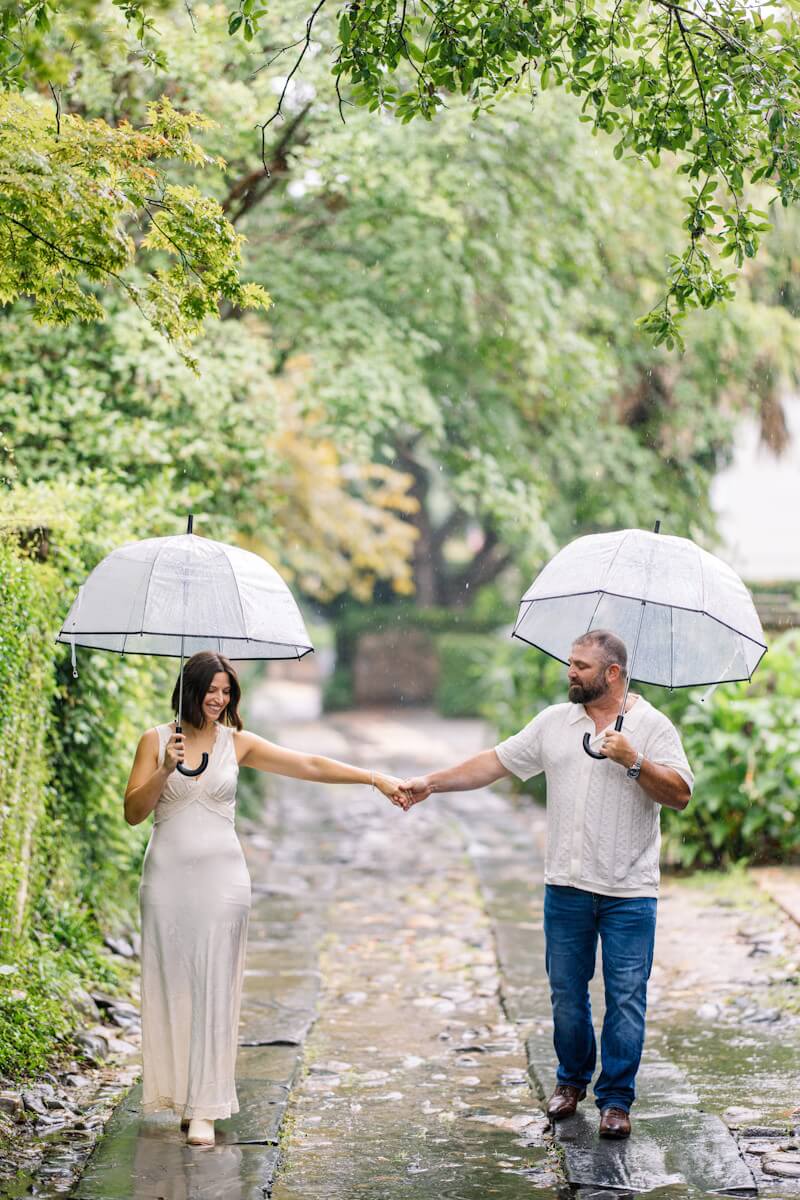 Groom lifting bride on the beach during romantic elopement with ocean reflection