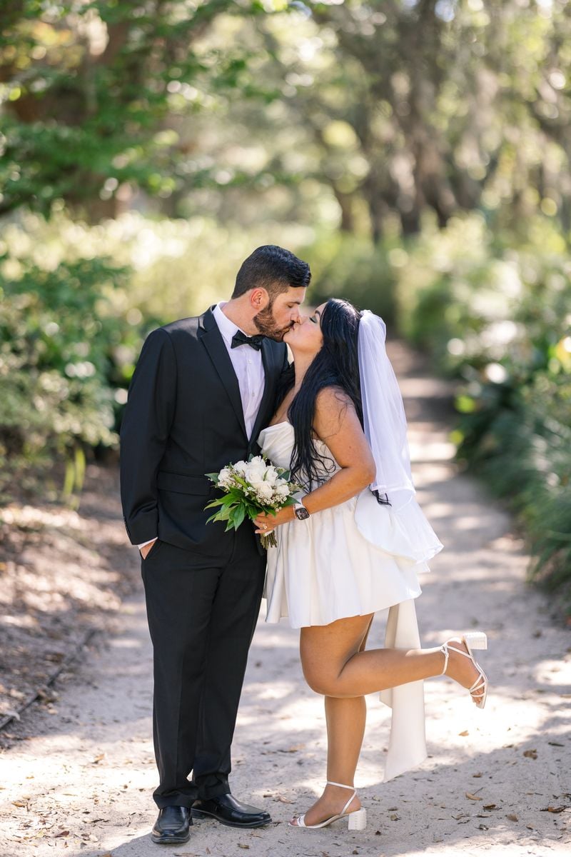 Couple exchanging vows under palm trees during intimate elopement ceremony